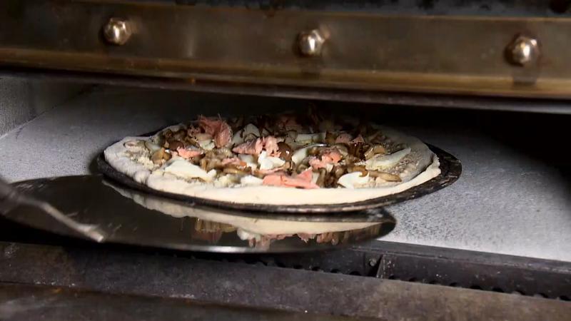 ピザをオーブンに入れている